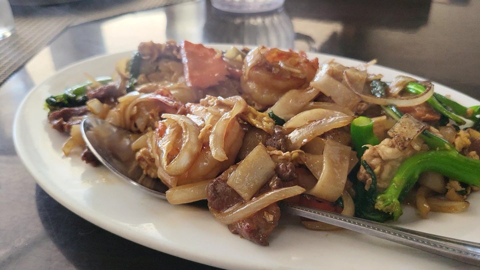 Thai dishes served in a cozy dining room.